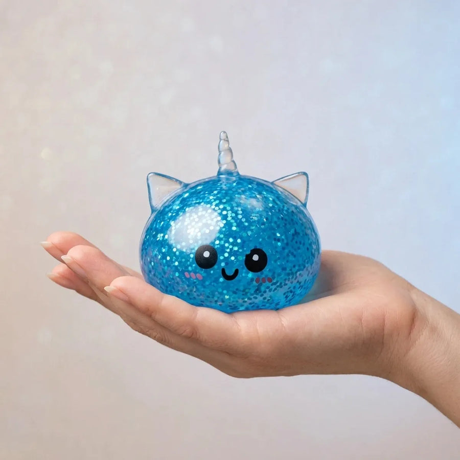 Blue unicorn dumpling squishy held in hand for size